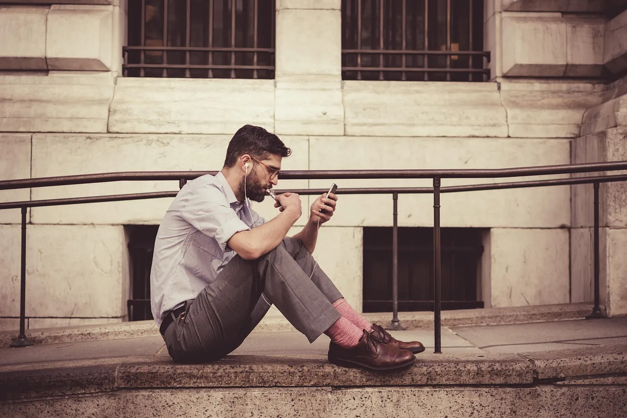 Person looking at their phone to leave a review