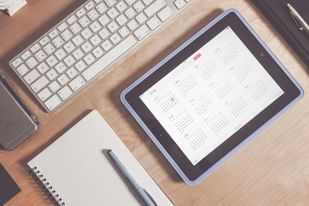 Calendar and tablet on a desk, online appointment booking