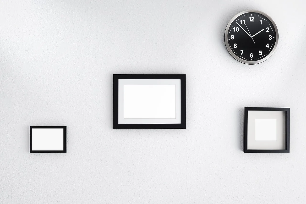 Wall clock above empty frames, symbol of hours