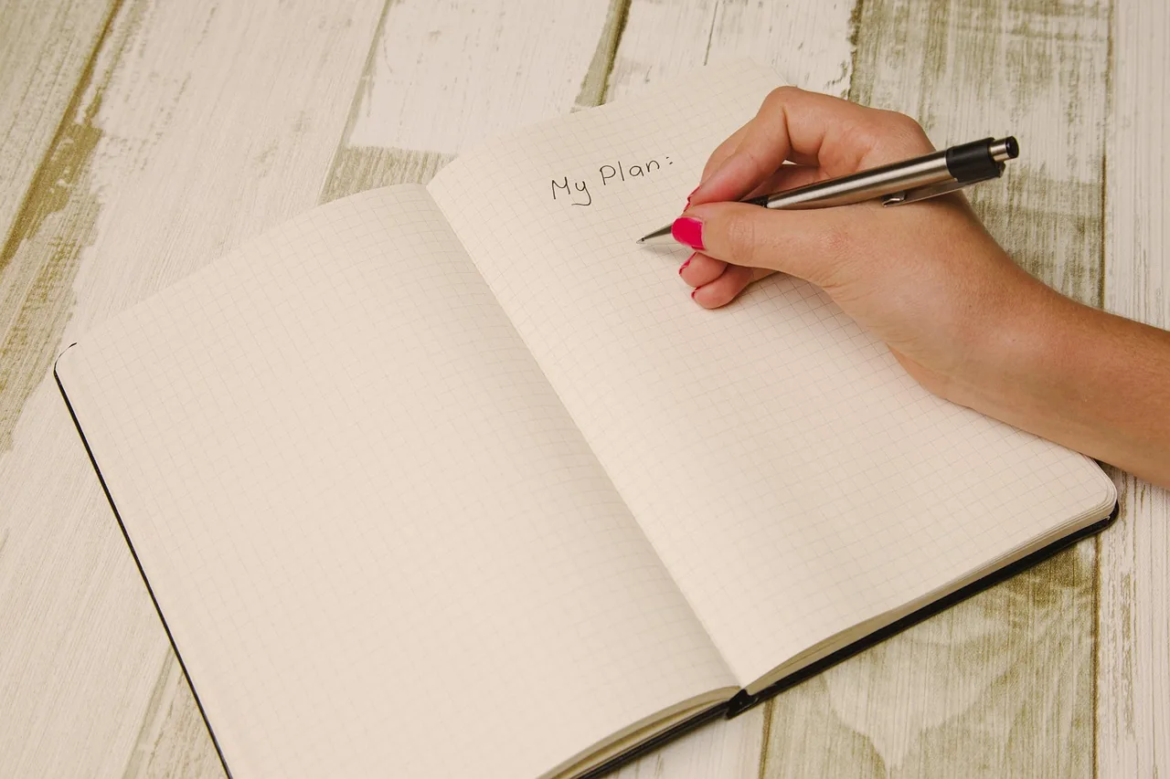 Hand writing in a paper diary to organize the practice's appointments