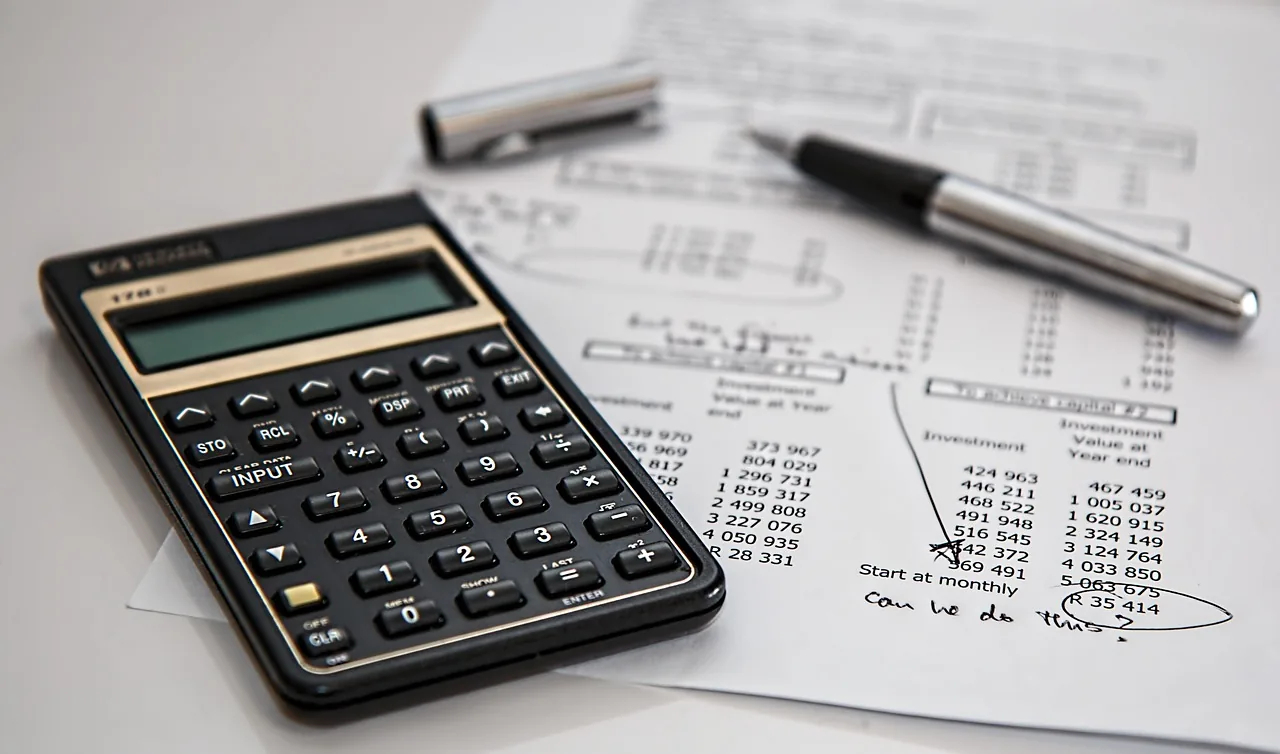 Calculator and ledger on a desk