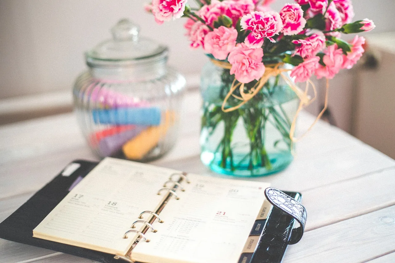 Open diary and calendar on a desk, with an appointment book