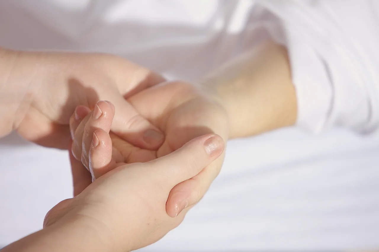Practitioner's hands during manual therapy