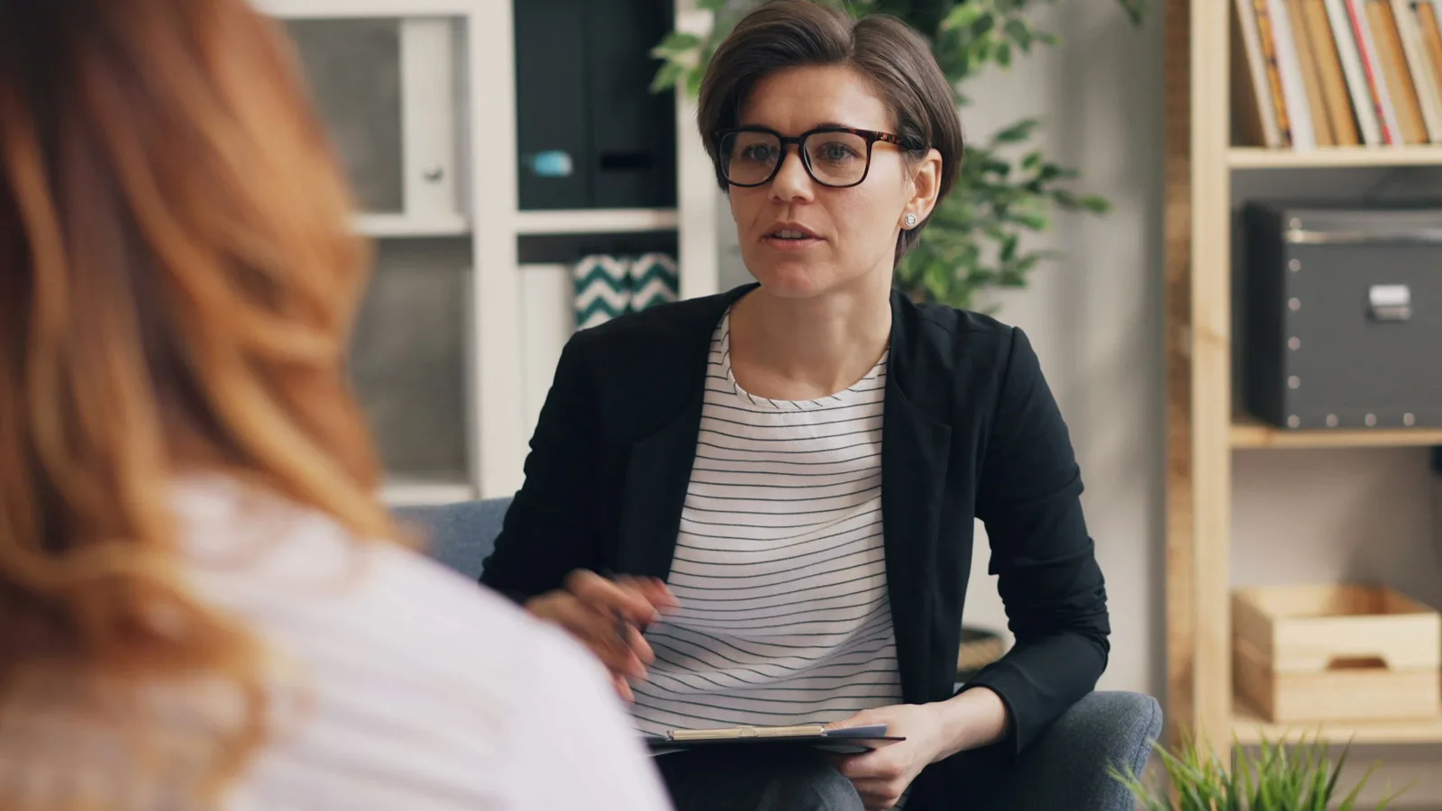 Consultation between a therapist and her client in a bright practice