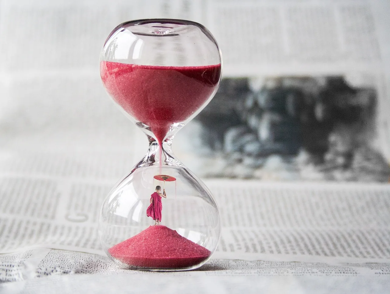 Hourglass on a table, symbol of time between two activities